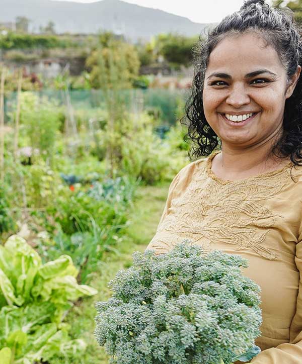 Hands working with agricultural tools in agroecological farming