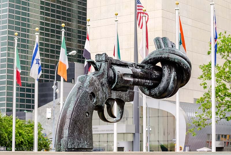 Bronze sculpture of a revolver with its barrel tied in a knot, displayed outside the UN building